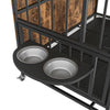 furniture dog crate shown with feeding bowls